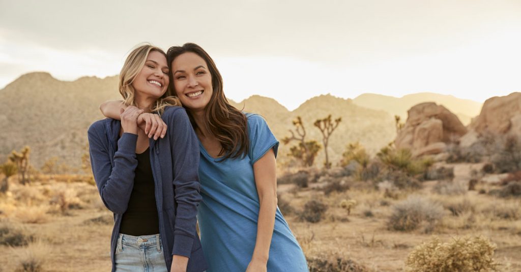 two women smiling in the desert