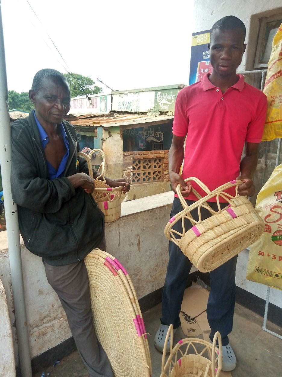 two men on a balcony holding baskets