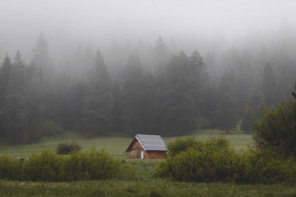 A hut in a foggy valley. Do Solar Panels Work in Winter?