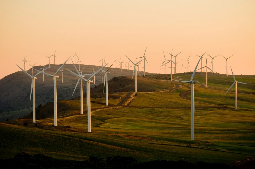Sustainability of Wind Energy: turbines across rolling green hills