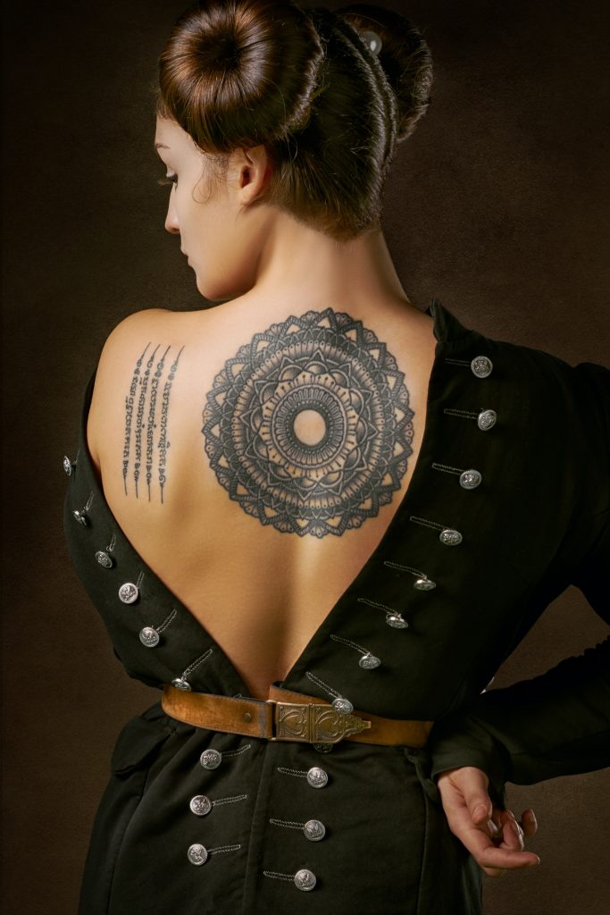 woman with round tattoo on back