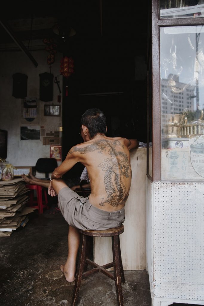 A History of Tattoos in Society, Man on a stool