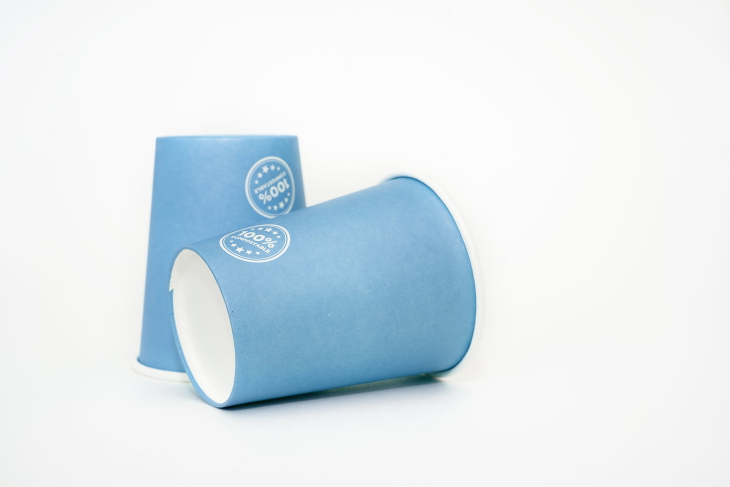 Compostable Coffee Cups: paper cups recyclable in blue on a white background. ecological concept