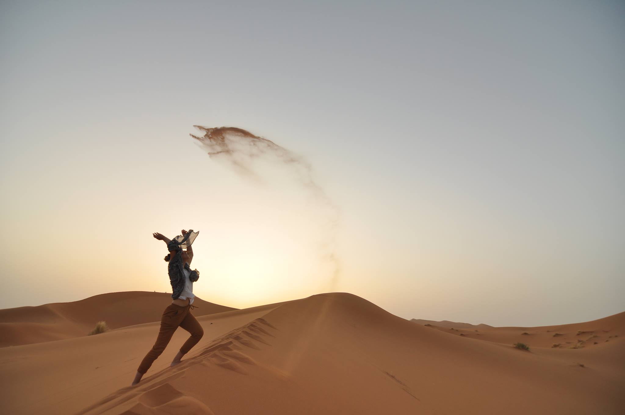 Travels Podcasts: Woman dancing in desert