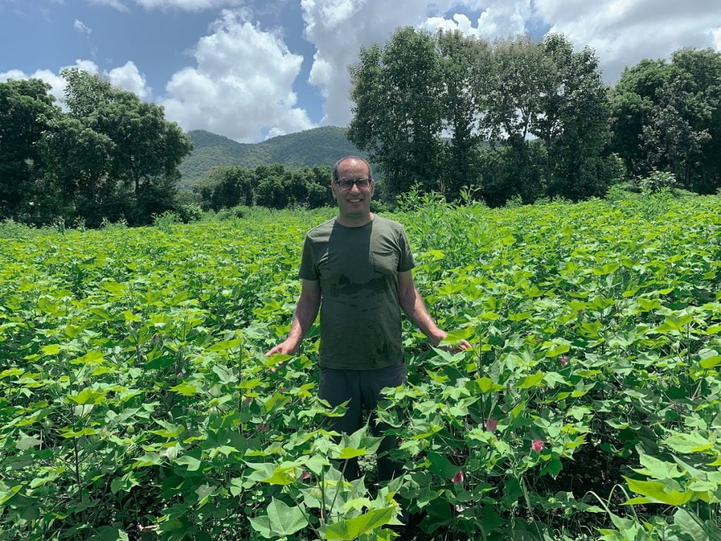 Gallant's CEO, Vik Giri, standing in a lush green farm field