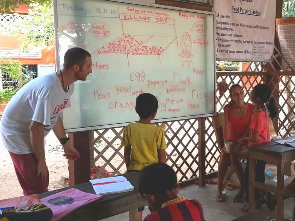 How To Make Your TEFL Teaching More Eco-Conscious: Teachers and children with whiteboard
