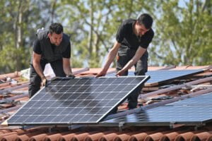 Why Do You Need CEC Accredited Solar Installers? Two men installing a rooftop solar panel