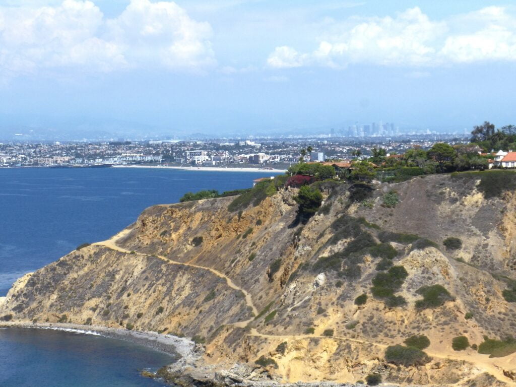 ocean, rugged cliffes, and Los Angeles in the far-off distance