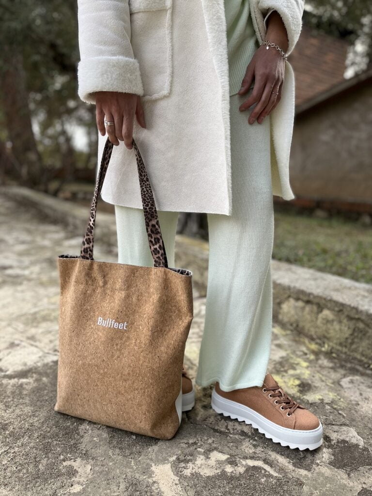 lady in white clothes with Bullfeet bag