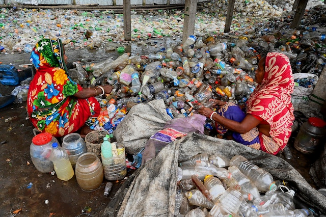 colourfully-dressed ladies sorting waste bottles