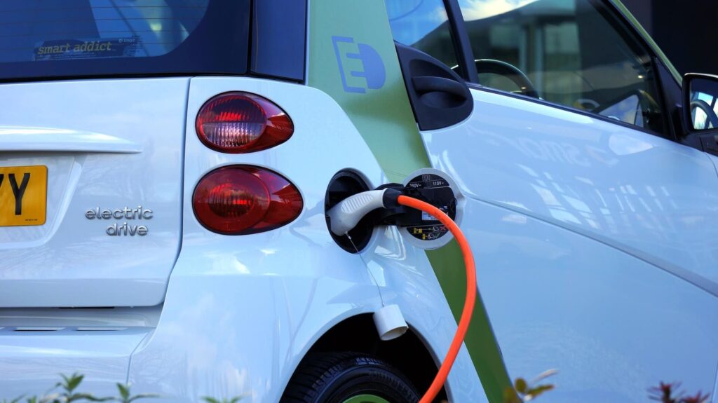 white electric vehicle plugged in