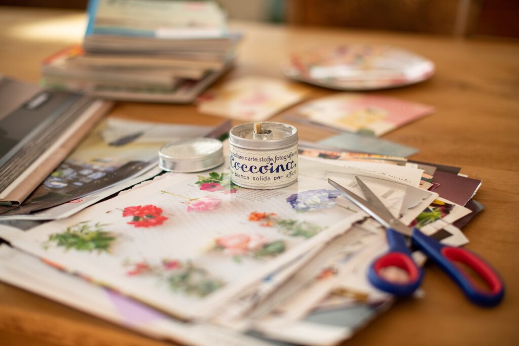 Ways to Save Trees: Vintage paper from magazines and a pair of scssors set up on a craft table