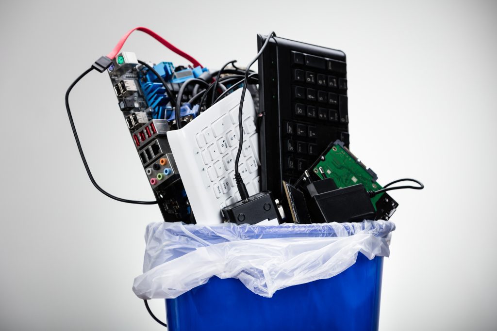 Sustainable Electronic Devices: Keyboards and other parts from a personal computer in a trash bin